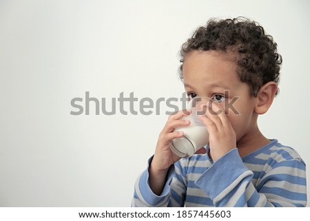 boy drinking milk for breakfast on white background stock photo