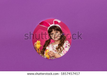 Cute little girl with Easter bunny ears holding 