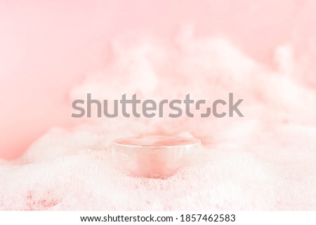 Abstract empty podium with suds on pastel pink background for presentation and exhibitions cosmetic product. Minimal concept.