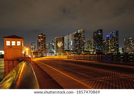 Miami Florida, sunset panorama with colorful illuminated business and residential buildings and bridge on Biscayne Bay
