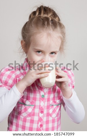 kid girl drinking yogurt or kefir