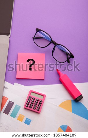 Question mark on sticky notes on office desk. FAQ concept. Working with clients. Vertical image