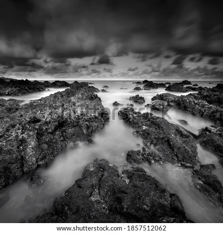 Art of black and white image.Amazing nature of unique rocks formation and beautiful morning light at Pandak Beach located in Terengganu, Malaysia.Soft focus due to long exposure. 