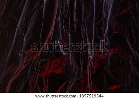 abstract red and black texture of crumpled plastic film for Wallpaper and backgrounds