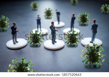 Miniature businessmen practicing social distancing to slow the spread of the deadly coronavirus Royalty-Free Stock Photo #1857520663