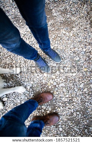 top view of couple feet and their dog