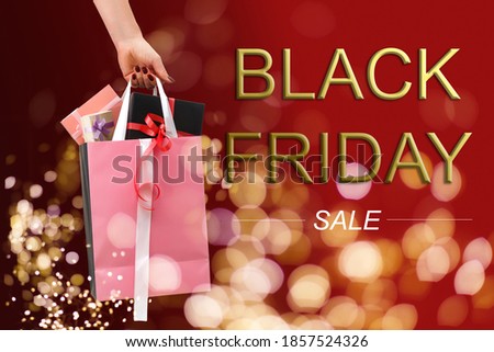 paper shopping bags, packages with purchases and the inscription black friday on a dark background