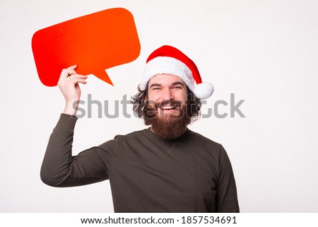 Thinking something, portrait of smiling man with beard looking at the camera and holding speech bubble