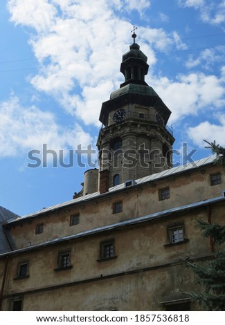 Clock tower of the cathedral on a background of blue sky with clouds. Bernardine Church