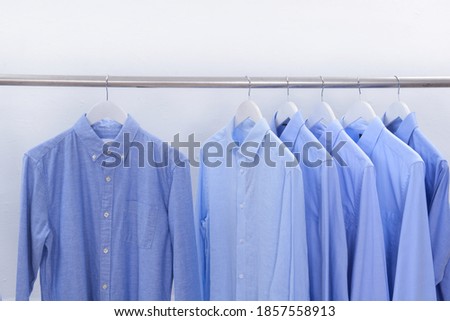 Men's blue , white, striped long sleeved  shirts on hanger