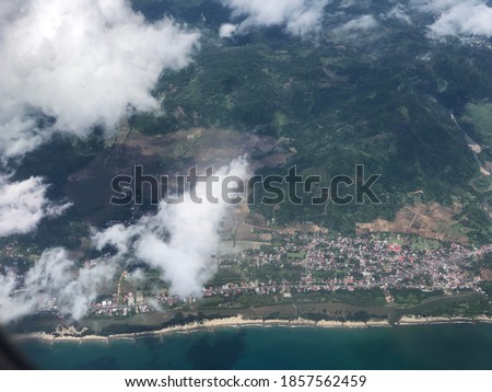 Padang city in coastline with a little cloudly take picture in flight - West Sumatera Indonesia