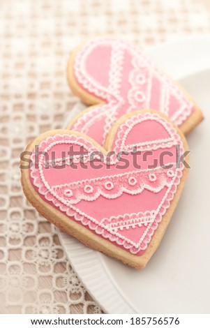 Heart shaped cookies hand decorated with royal icing lace technique. Lovely for Mother's or Valentine's Day or wedding related content.