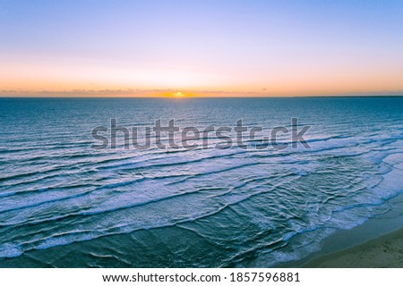 Ocean at sunset - minimal aerial seascape with horizon over water