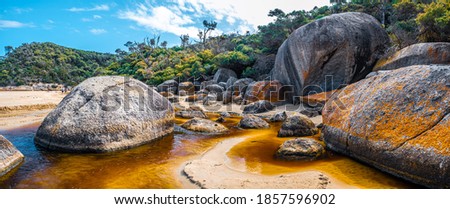 Panorama of brown water of Tidal River and huge boulders. Wilsons Promontory, Victoria, Austrlaia Royalty-Free Stock Photo #1857596902