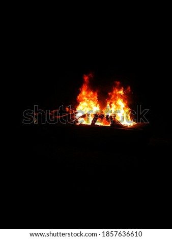 Old car set ablaze at night