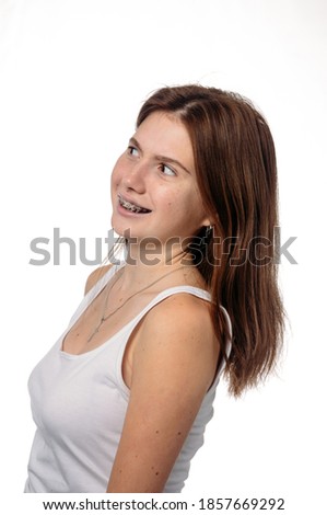 young girl in braces on a white background