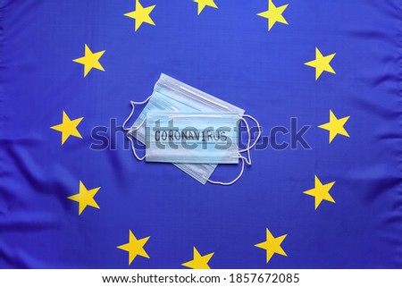 Protective masks on European Union flag background, top view. Coronavirus outbreak