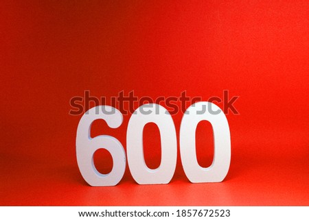 Mockup Six Hundred ( 600 ) white wooden number  Isolated Red Background with Copy Space - New promotion 600% Percentage  Business finance Concept                              
