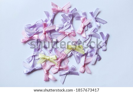 Craft, needlework concept. Colorful ribbon bows on white background, Top view.