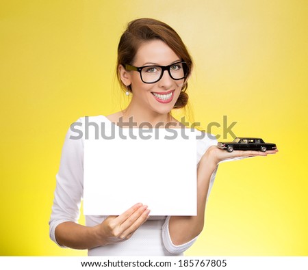 Closeup portrait smiling business woman in dress, black glasses, holding small car model, blank white paper in hands offering sign loan, lease agreement, isolated yellow background. Bank financing