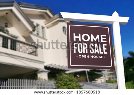A Home for sale and open house sign in front of a large gated house in a subdivision.