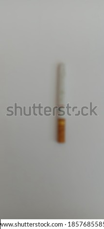 A cigarette on a white background, blur picture camera 