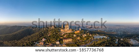 Panoramic aerial drone view of Sacred Heart Basilica on top of Tibidabo near Barcelona during sunset