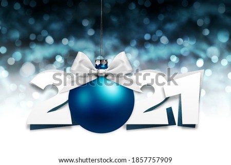 2021 number text with blue christmas ball and silver ribbon bow isolated on blurred lights background for happy new year greeting gift card