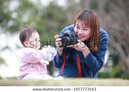 Mother taking a picture of the baby