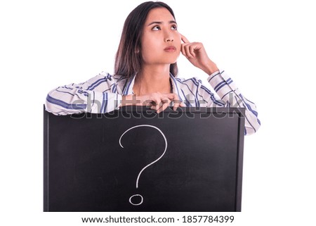 Beautiful sad Asian female model holding blackboard with Question Mark sign on it.