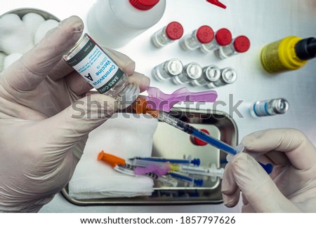 Nurse draws with a covid-19 vaccine syringe with high effectiveness from a specific laboratory, conceptual image Royalty-Free Stock Photo #1857797626