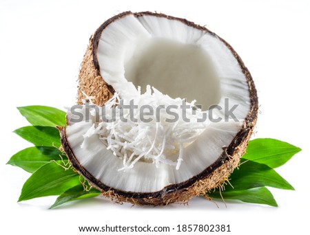 Cracked coconut fruit with white flesh and shredded coconut flakes isolated on white background. Royalty-Free Stock Photo #1857802381