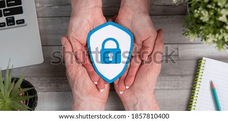 Concept of protect and security with paper shield in hands
