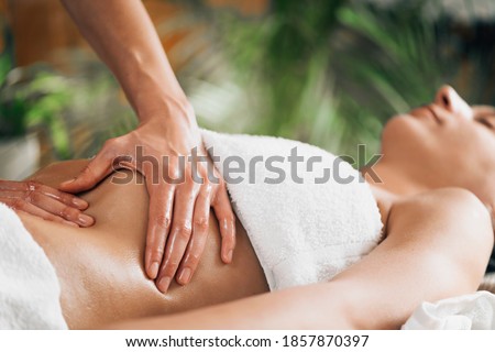 Ayurveda stomach massage in salon Royalty-Free Stock Photo #1857870397