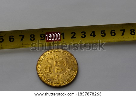 golden crypto coin in tape measure 18000 background