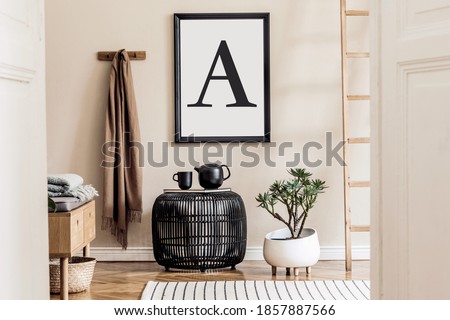 Japandi style living room with mock up poster frame, design wooden commode, unique furniture, decoration and elegant personal accessories. Neutral interior in scandinavian house. Cozy home decor.