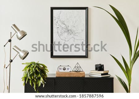 Stylish composition of living room interior with design black commode, a lot of plants, mock up poster map, decoration, silver lamp and elegant personal accessories. template. Modern home decor.