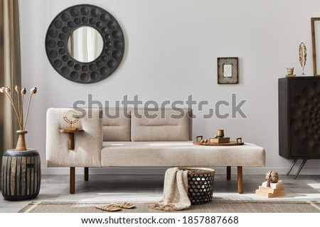 Interior design of ethnic style living room with modern commode, round mirror, decoration, furniture and personal accessories. Template. White wall. Royalty-Free Stock Photo #1857887668