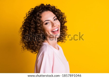 Photo portrait of laughing girl isolated on vivid yellow colored background
