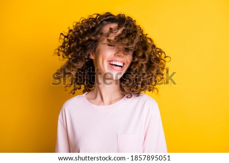 Photo portrait of cool girl with wavy flying hair isolated on vivid yellow colored background Royalty-Free Stock Photo #1857895051
