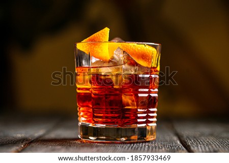 Negroni cocktail with gin in old fashion glass on the blurry background Royalty-Free Stock Photo #1857933469