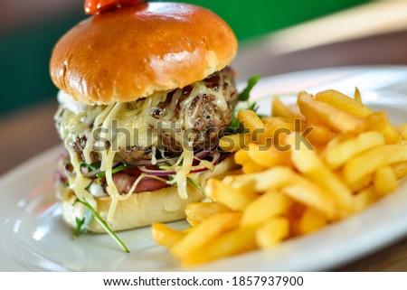 burger with French fries cutlet with cheese and tomato