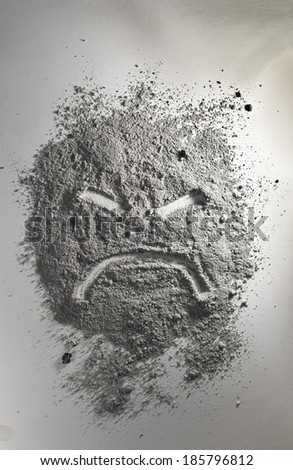 Angry emoticon made of grey ash