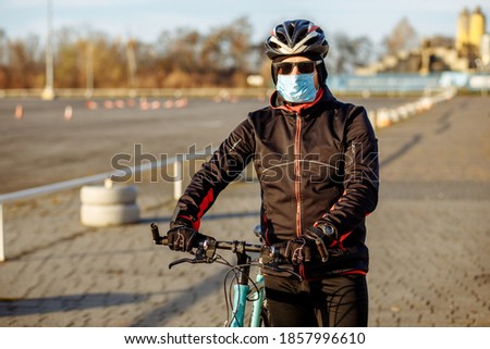 cyclist during quarantine rides a bicycle in a mask