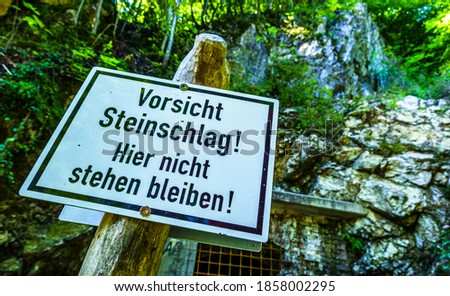 rock fall warning sign in germany - translation: look out - rocks falling - dont stay here