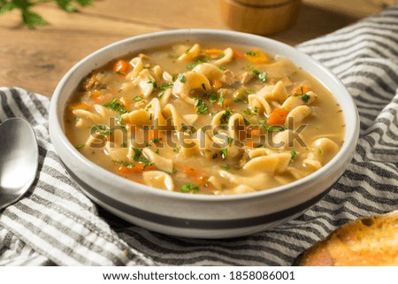 Homemade Chicken Noodle Soup with Peas and Carrots