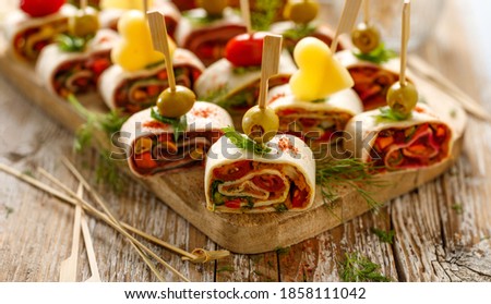 Vegetarian tortilla roll ups with vegetable filling close up view Royalty-Free Stock Photo #1858111042