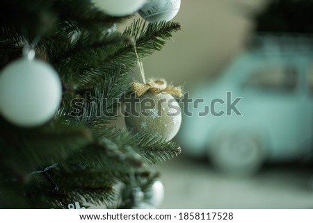 Christmas ornament in the form of a sphere hangs on a branch of the New Year's fir-tree. Christmas knickknacks