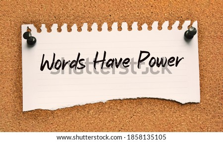 Paper note written with WORDS HAVE POWER inscription on cork board