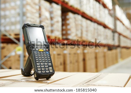 Bluetooth barcode scanner in front of modern warehouse Royalty-Free Stock Photo #185815040